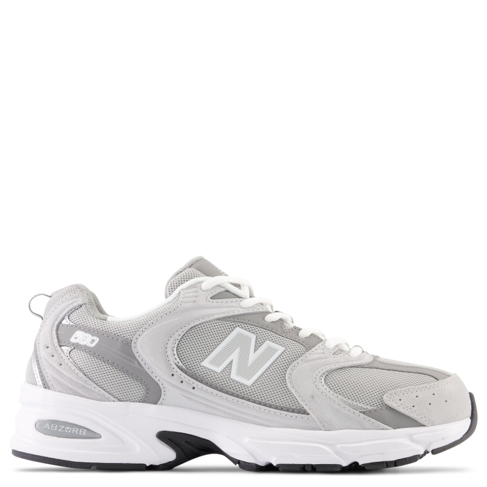A pair of New Balance 530 grey sneakers with a mesh and synthetic overlay upper design, featuring sweeping curves and angles.