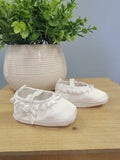 Satin and ruffle white baby booties.