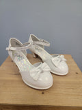 white girls shoe with ankle strap and bow on toe
