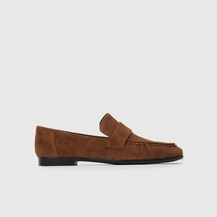 Brown loafer shoe on a light gray background | Lead