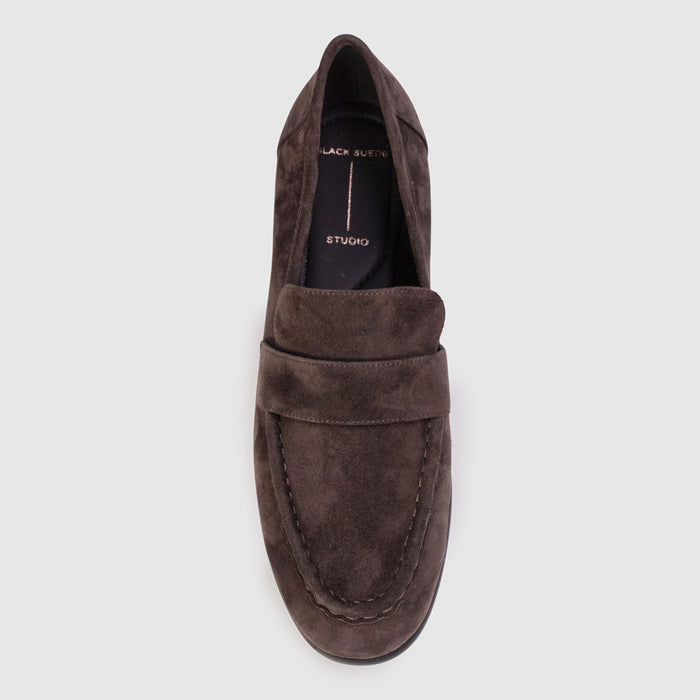 Brown suede loafer shoe on a light gray background