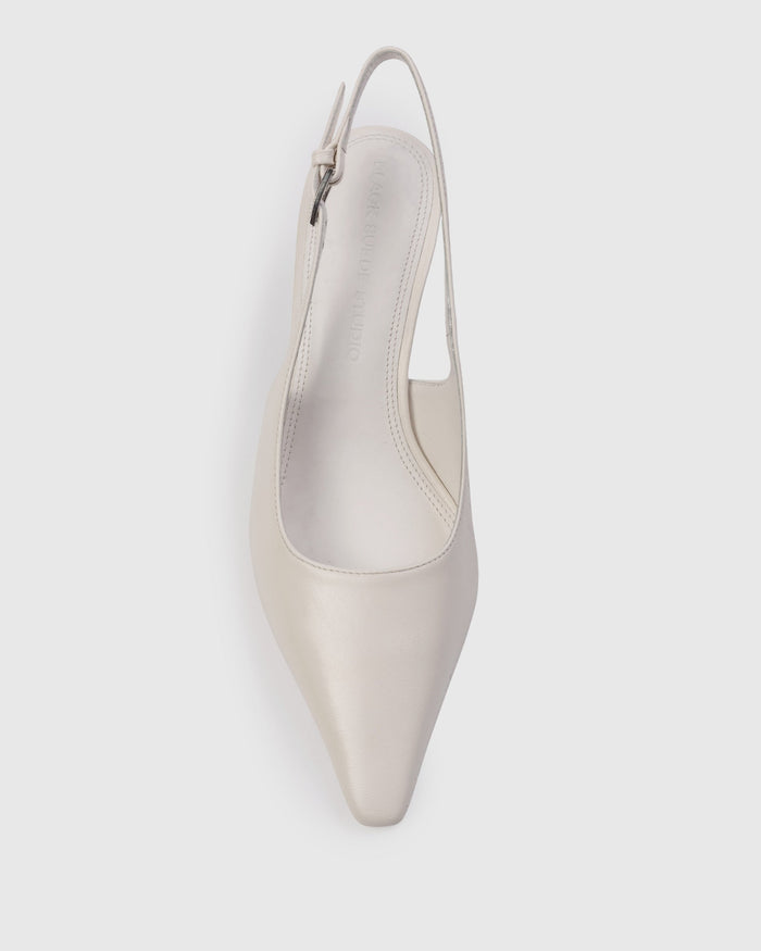 White pointed-toe slingback pump on a light gray background | Exclude