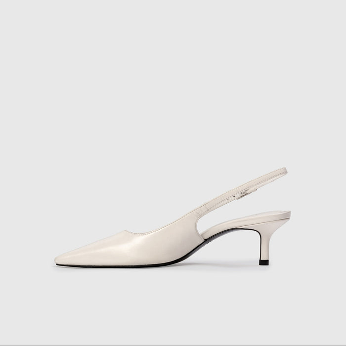 White slingback shoe on a light gray background
