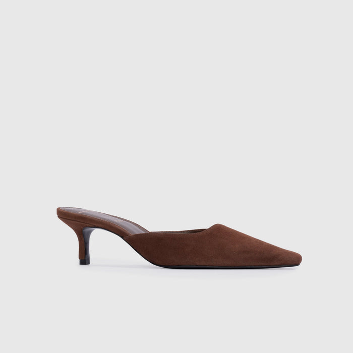 Brown suede slipper on a light gray background