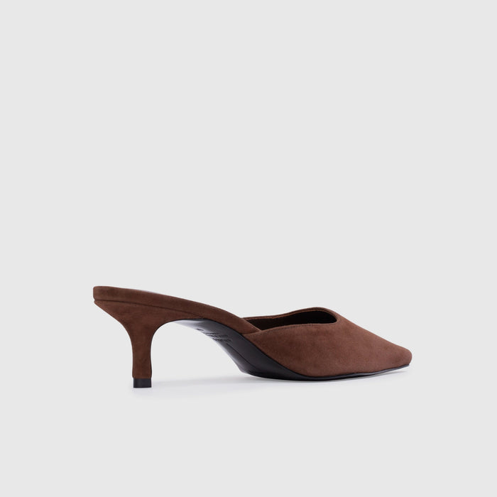 Brown high-heeled shoe on a light gray background