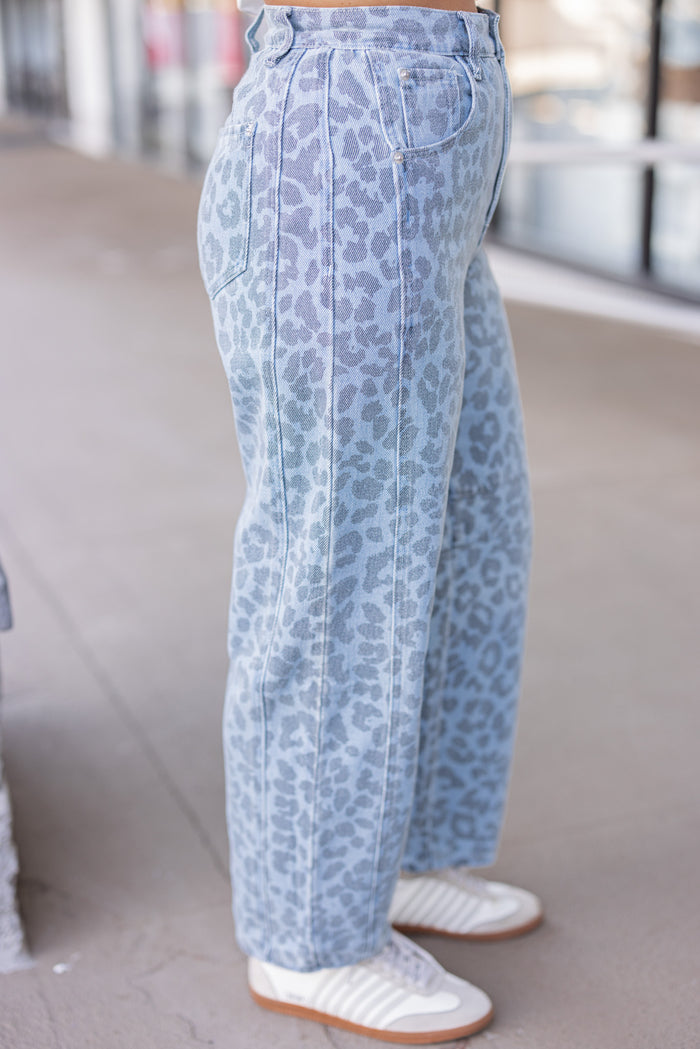 Washed blue and black leopard print barrel denim pants by Entro showing up close side view