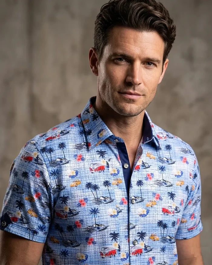 Man wearing a colorful patterned shirt against a neutral background