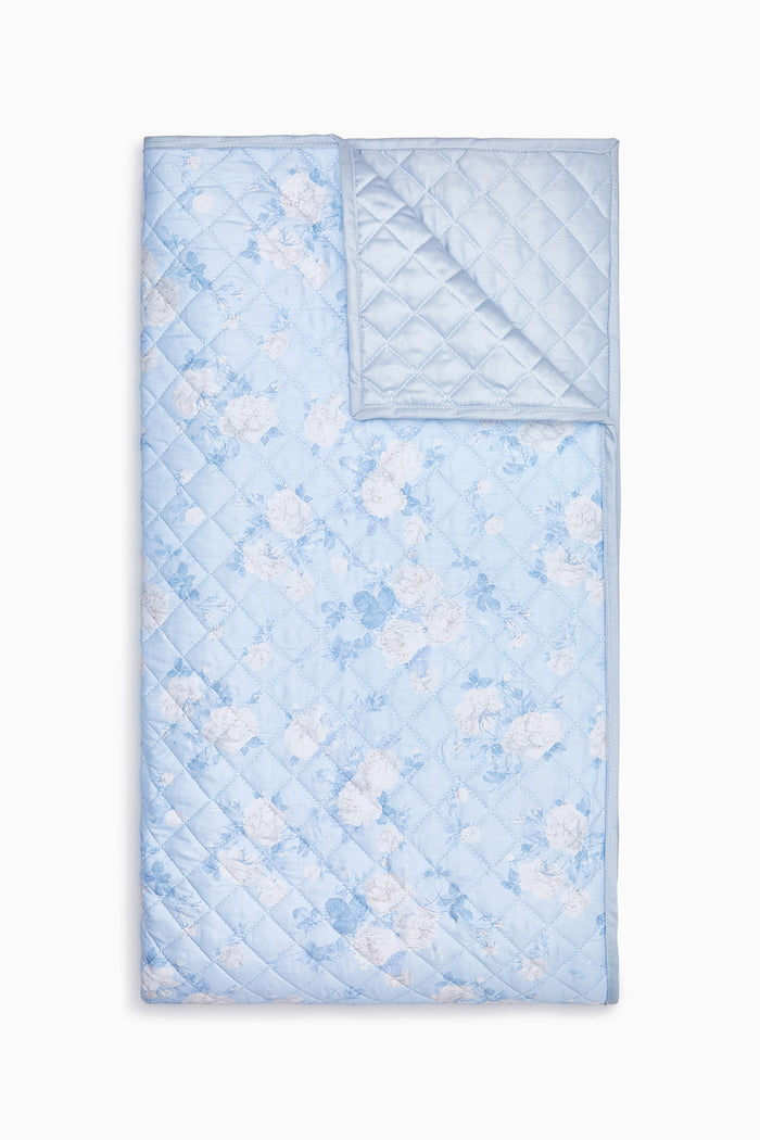 Quilt with a blue and white pattern on a white background