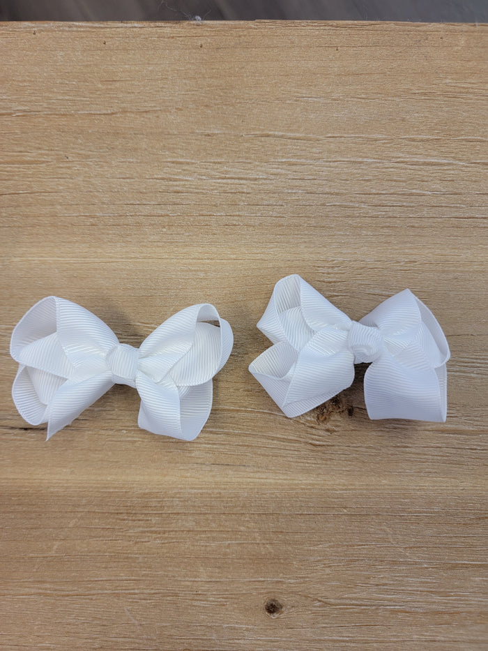 Two small white ribbon bow hair clips.