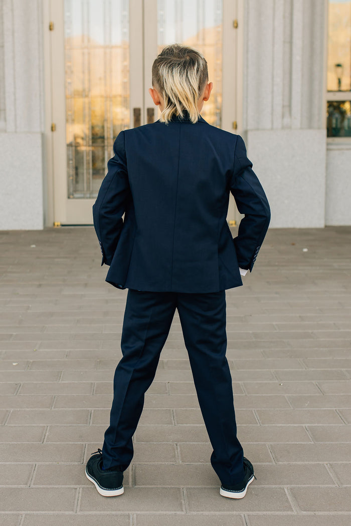 boy in navy suit-back view