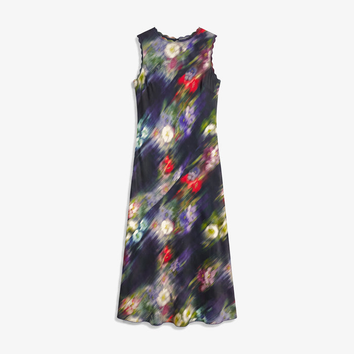 A sleeveless midi dress with a dark abstract floral print featuring purple, red, green, and yellow bokeh-like circles on a black background, shown against a light gray studio backdrop.