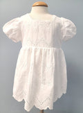 White baby dress with eyelet and scalloped design.