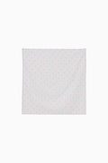 Blue fabric square with a subtle floral pattern on a white background