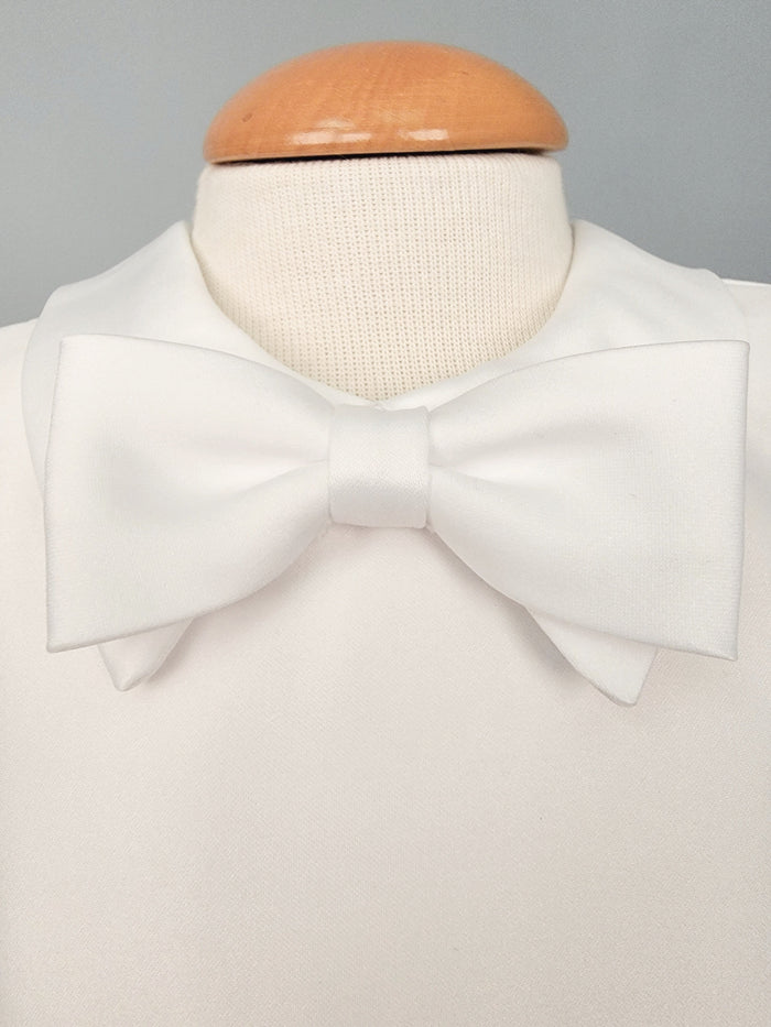 White bowtie on baby boy outfit.