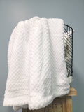 White fleece blanket in basket.