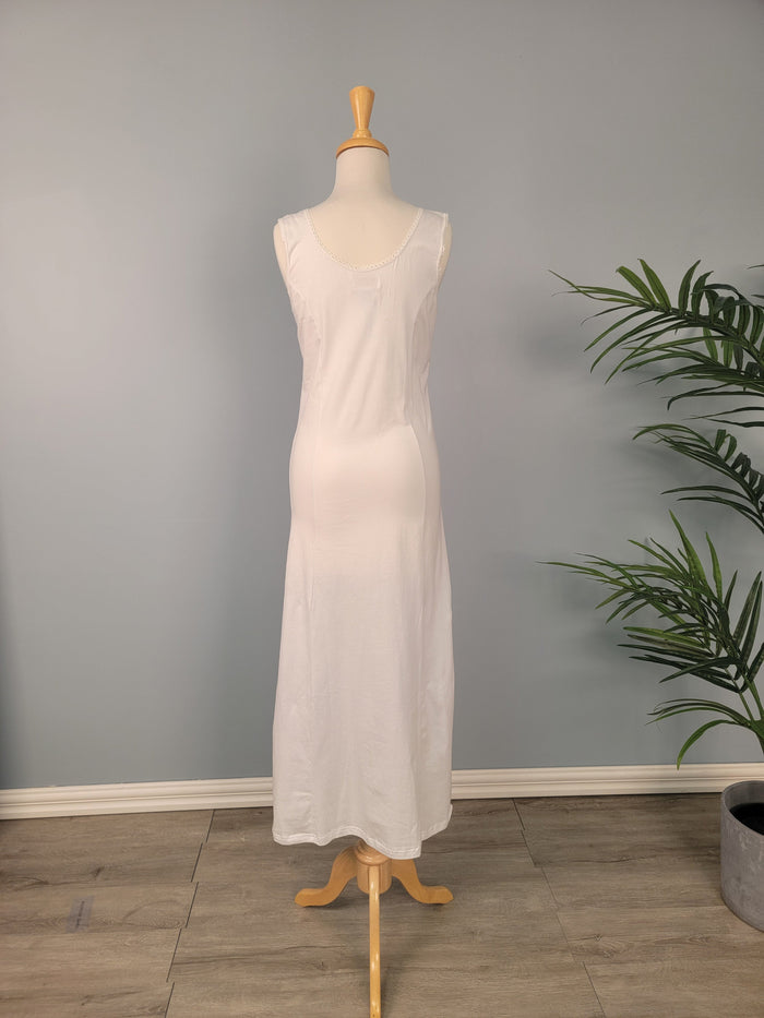 Full length white cotton slip with hem pocket.