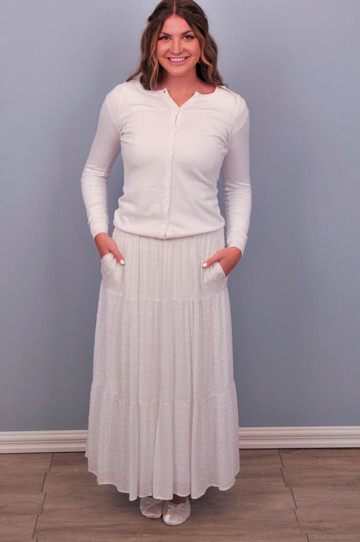 White crew neck button up cardigan on model.