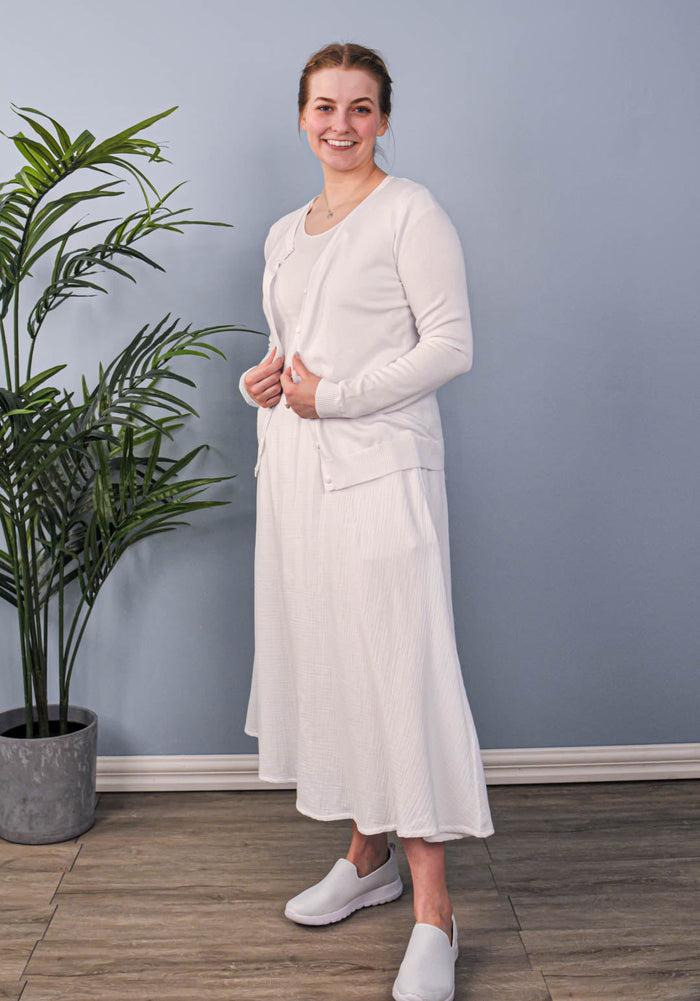 White crew neck button up cardigan on model.