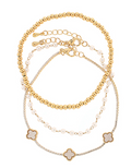 Set of layered gold clover and pearl bracelets