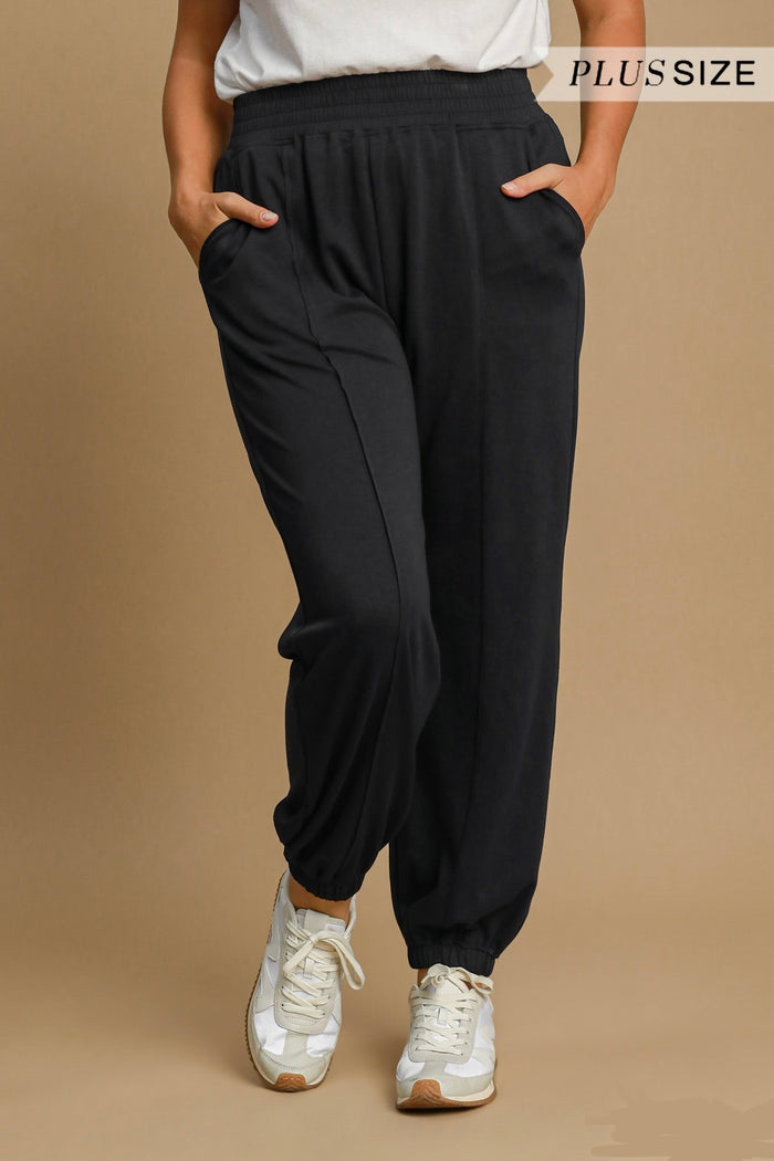 Women's black scuba luxe knit jogger pants with raw/reverse seam details by Umgee in plus size