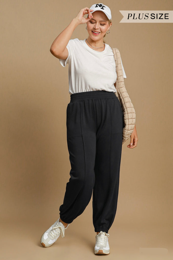 Women's trendy black scuba luxe knit jogger pants with raw/reverse seam details by Umgee in plus size