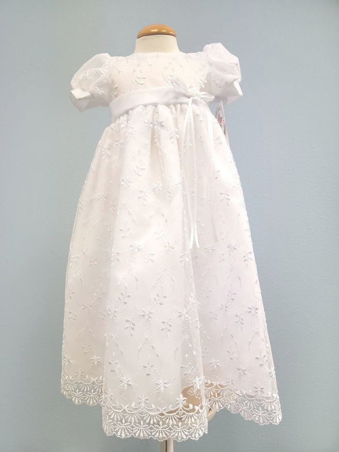 White baby gown with floral embroidery.