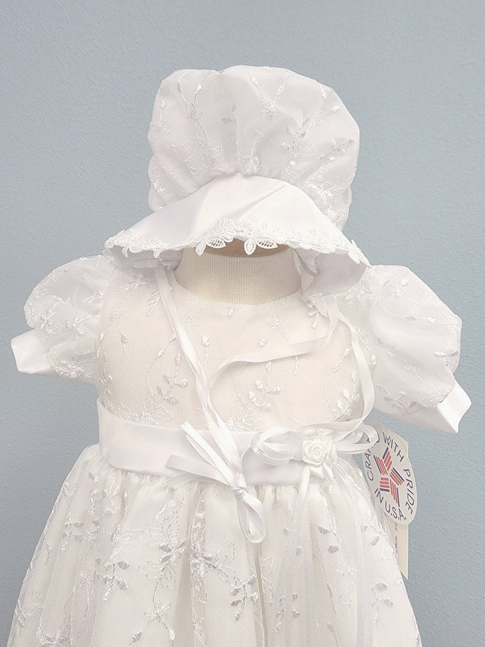 White baby gown with floral embroidery and matching bonnet.