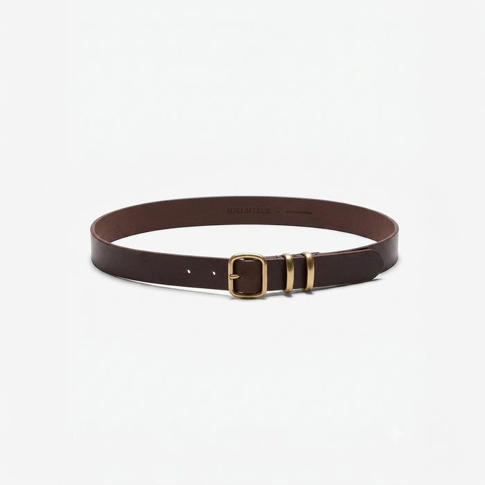 A dark brown leather belt with a gold-tone buckle and matching gold-tone tip, displayed on a clean white background. | Lead