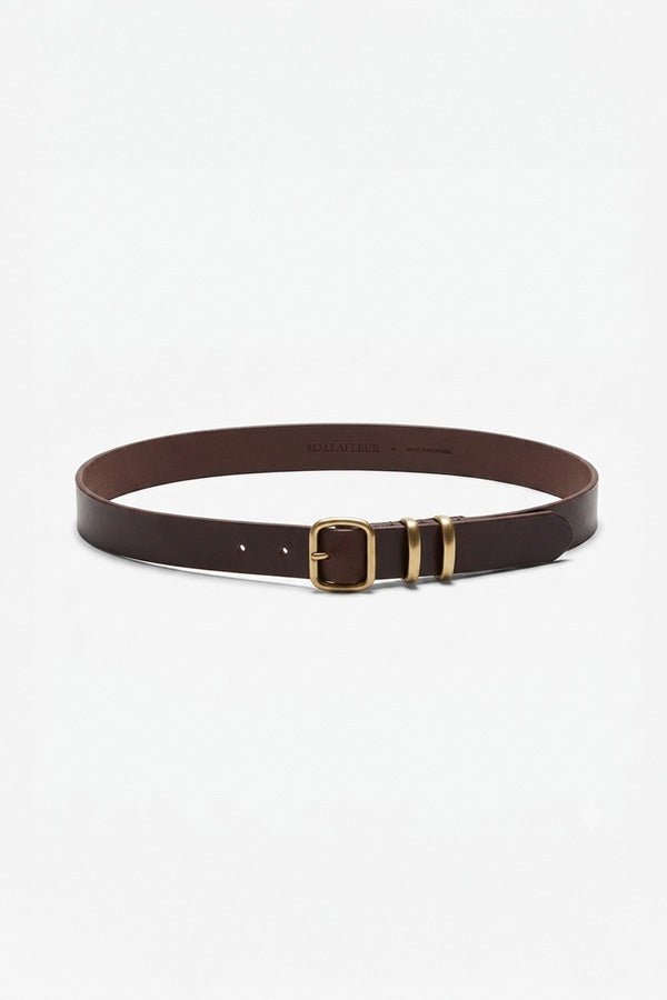 A dark brown leather belt with a gold-tone buckle and metal keeper loops, displayed on a clean white background. | Grid | Exclude