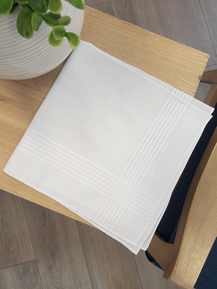 White handkerchief with white striped edges.