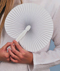 White paper fold out hand fan