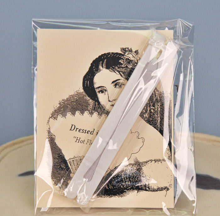 White paper fold out hand fan in packaging