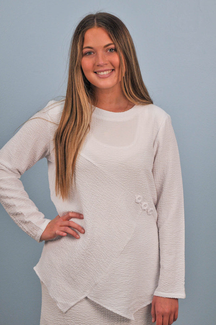 woman in white blouse with flower buttons