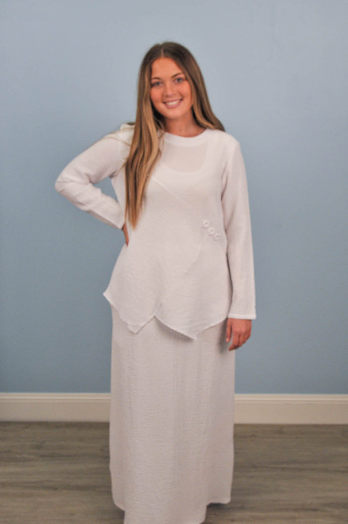woman in white blouse with matching skirt