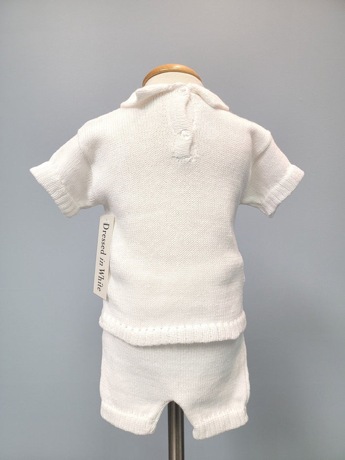 Back of white knit baby boy outfit.