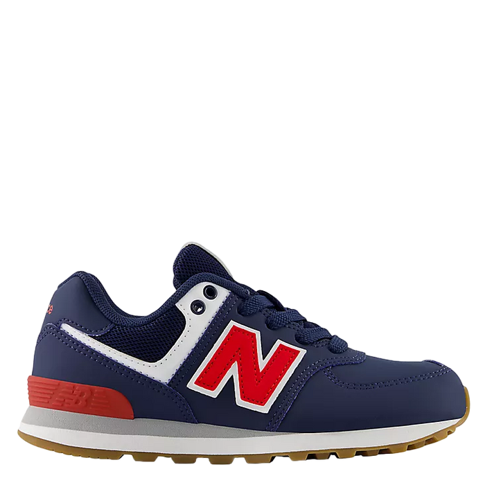 Navy blue and red sneaker with New Balance logo on a white background