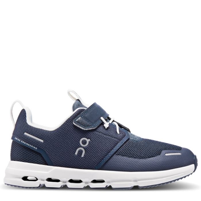 A navy blue and white On running sneaker designed for kids, featuring a hook and loop closure and a flat sole.