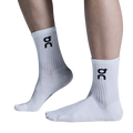A pair of white high-top socks with the logo 'dc' on the side.
