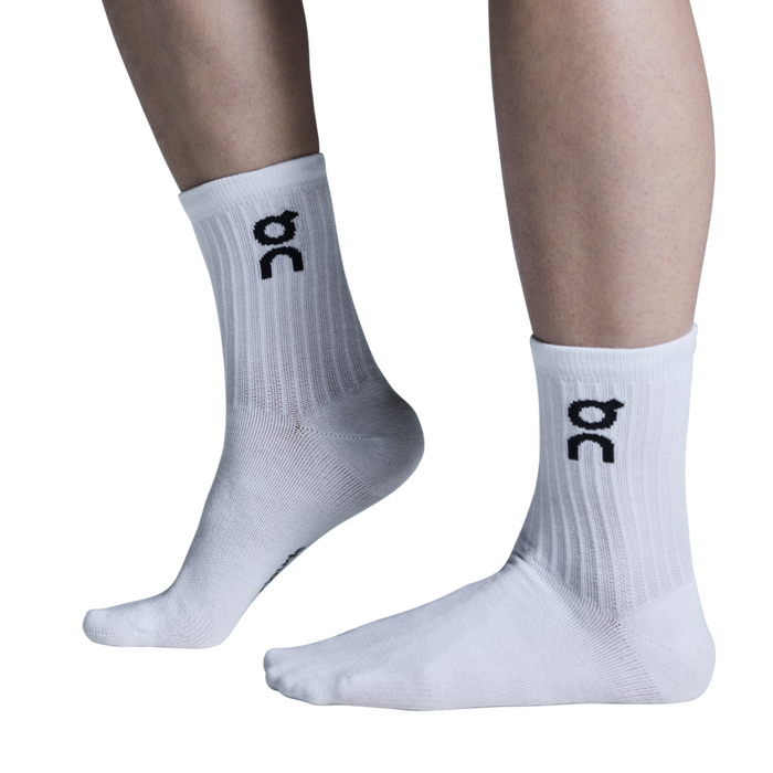 A pair of white high-top socks with the logo 'dc' on the side.
