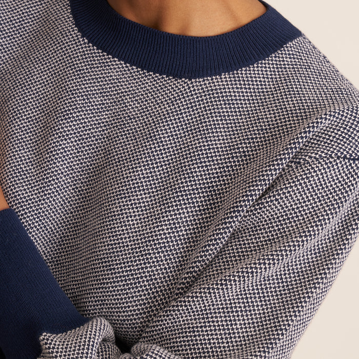 Women in birdeyes sweater and jeans.  | Exclude