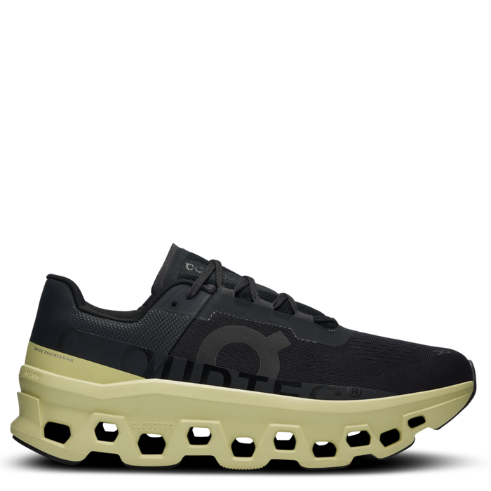 A pair of men's running shoes with a black upper and a unique cushioning system in the sole.