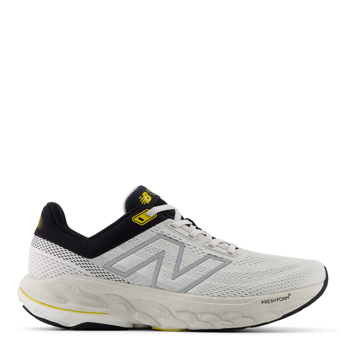 A pair of New Balance Fresh Foam X 860v14 running shoes in white, black, and gray colors with the brand logo visible.