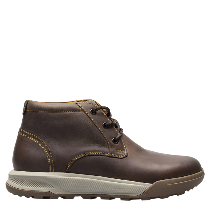 A brown, plain toe chukka boot with lace-up closure and a rubber outsole.