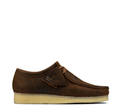 A brown men's wallabee shoe with a crepe sole and beeswax upper, featuring a lace-up closure and a branded label on the side.