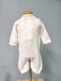 White knit baby boy romper with buttons.