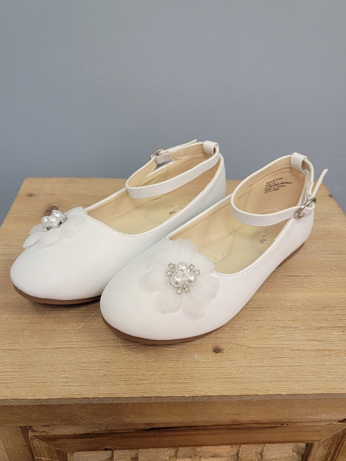 girl's white shoe with strap and flower on toe