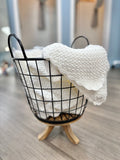 Popcorn knit baby blanket in basket.