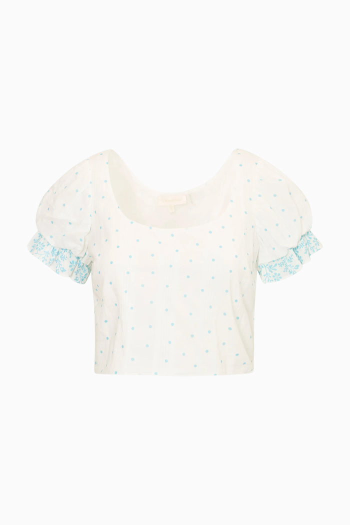 White blouse with blue ruffled sleeves on a white background