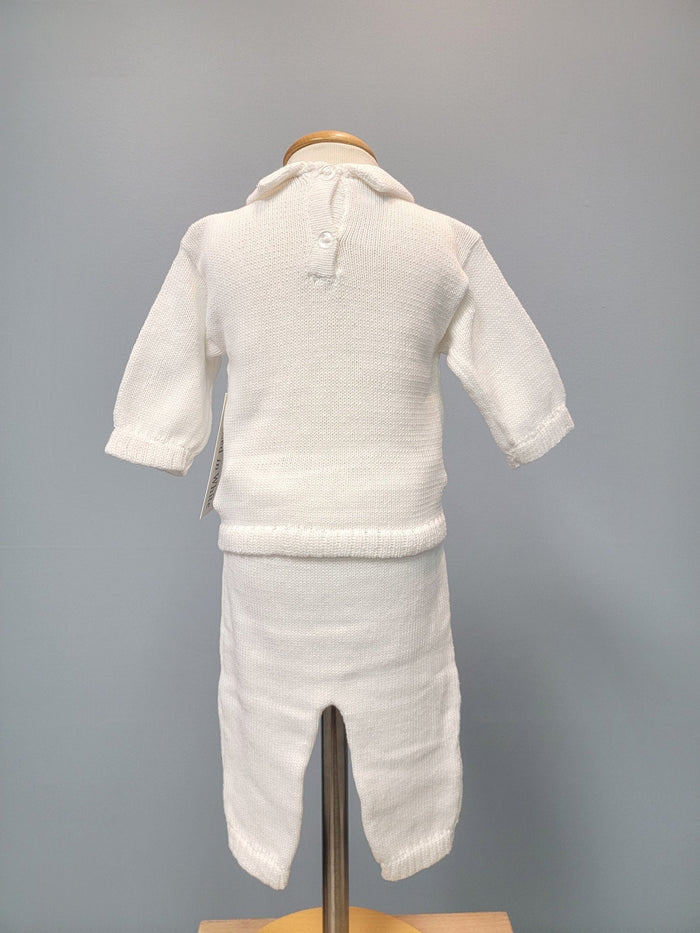 Back of white knit baby boy outfit with long pants.