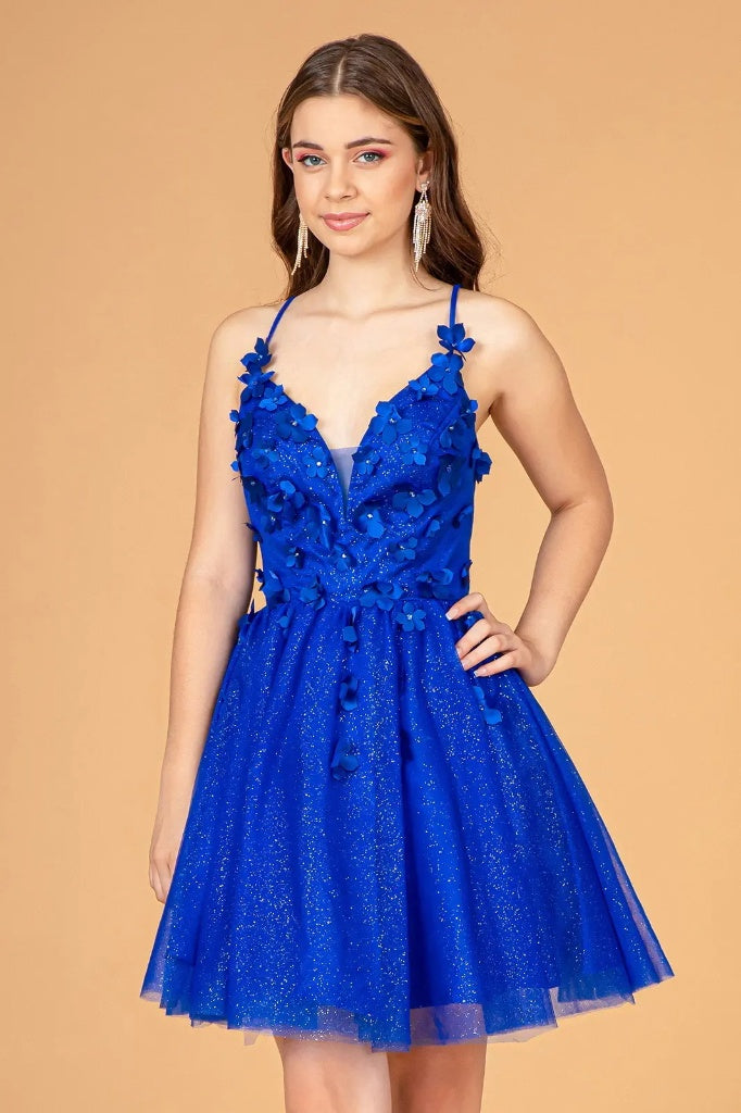 Woman wearing a blue lace dress against a beige background